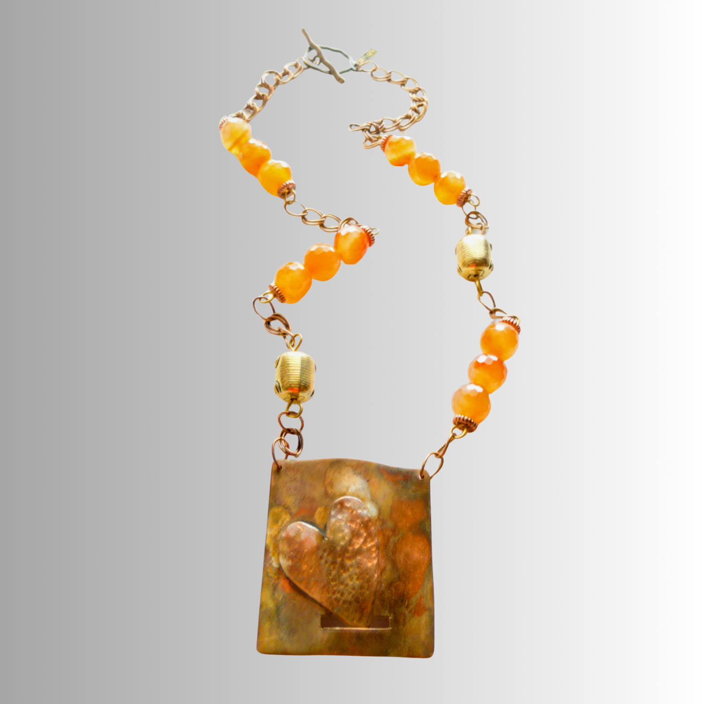 Heart-shaped flame-painted copper necklace with faceted Carnelian beads by SOUFiiARTe