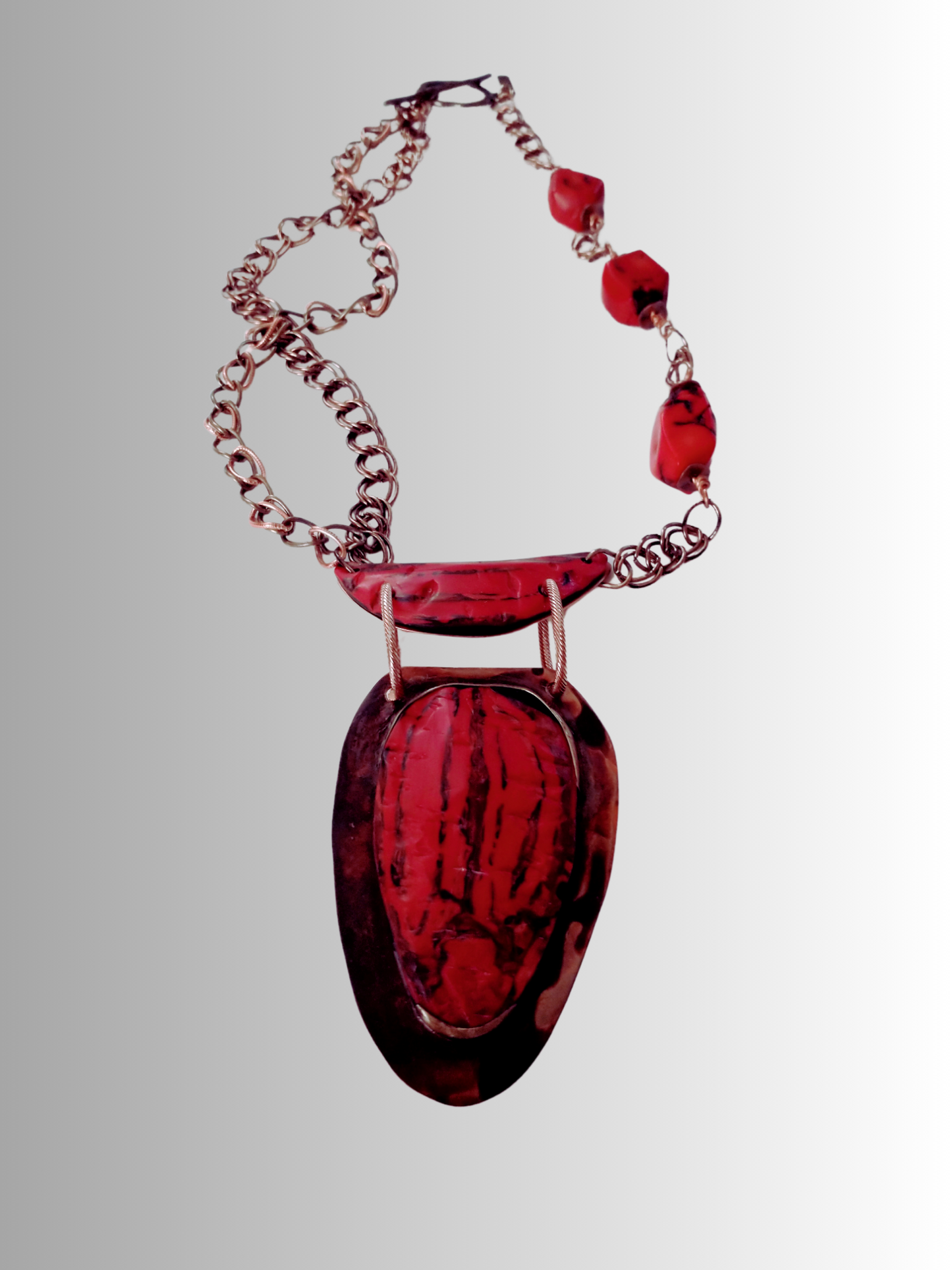 Crimson red polymer pendant with copper base and coral-red chain, handcrafted by SOUFiiARTe