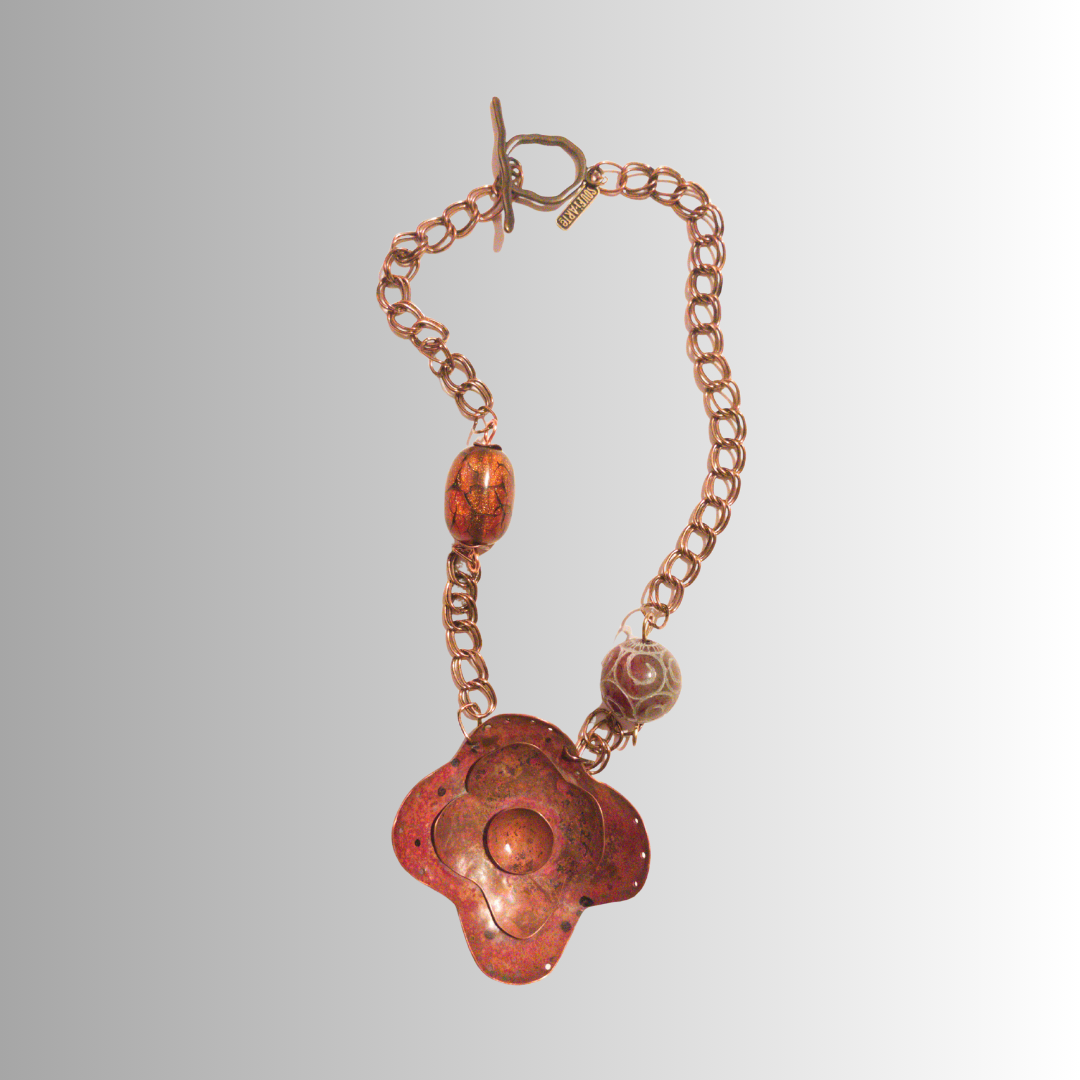 Hand-forged flame-painted copper flower necklace with carved jade bead and brass chain from SOUFiiARTe.