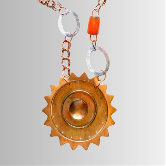 Sun eclipse-inspired copper pendant bead necklace with central moon phase design, handcrafted by SOUFiiARTe.
